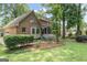 Rear exterior brick home featuring a screened porch and backyard with lawn at 829 Bev Ct, Lawrenceville, GA 30046