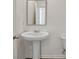 Pedestal sink in a half bathroom with framed mirror and tiled flooring at 8587 Secretariat Dr, Lithonia, GA 30058