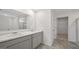 Well-lit bathroom with double sink vanity, tiled floor, and walk-in shower at 8587 Secretariat Dr, Lithonia, GA 30058