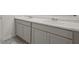 Bathroom vanity with double sinks, gray cabinetry, and a white countertop at 8587 Secretariat Dr, Lithonia, GA 30058