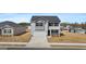 Charming two-story home featuring a gray exterior, a two-car garage, and manicured landscaping at 8587 Secretariat Dr, Lithonia, GA 30058