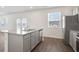 Bright kitchen with granite island, stainless steel appliances and gray cabinetry at 8587 Secretariat Dr, Lithonia, GA 30058