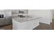 Large kitchen island with sink, stainless steel appliances and gray cabinetry at 8587 Secretariat Dr, Lithonia, GA 30058