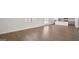 Open-concept living room with wood-look flooring leading into the kitchen at 8587 Secretariat Dr, Lithonia, GA 30058