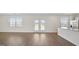 Expansive open-concept living area featuring hardwood flooring, natural light, and an eat in kitchen at 8587 Secretariat Dr, Lithonia, GA 30058
