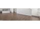 Bright and airy living area with wood-look flooring next to the kitchen and staircase at 8587 Secretariat Dr, Lithonia, GA 30058