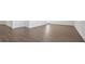 Spacious living room features wood-look flooring and neutral wall paint at 8587 Secretariat Dr, Lithonia, GA 30058