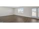 Spacious living area with hardwood floors, natural light and access to an outdoor patio at 8587 Secretariat Dr, Lithonia, GA 30058