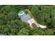 Aerial view of home featuring pool, large lot, circular driveway, and mature tree coverage at 9125 Patrick Pl, Winston, GA 30187