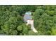 A high aerial shot showcasing the estate's pool, driveway, and dense tree coverage at 9125 Patrick Pl, Winston, GA 30187