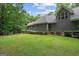 Expansive backyard featuring lush green grass, mature trees, and manicured landscaping at 9125 Patrick Pl, Winston, GA 30187