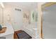 Bright bathroom featuring a tub, a tiled shower, a double sink vanity and framed botanical artwork at 9125 Patrick Pl, Winston, GA 30187