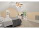Bright bedroom with a desk area, dormer windows, neutral carpet, and a connecting bath at 9125 Patrick Pl, Winston, GA 30187