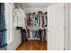 Walk-in closet with ample storage and hardwood flooring, perfect for organizing your wardrobe at 9125 Patrick Pl, Winston, GA 30187