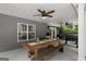 Covered patio featuring a ceiling fan, a large wooden dining table and a barbeque grill at 9125 Patrick Pl, Winston, GA 30187