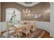 Formal dining room with decorative chandelier, hardwood floors, and large windows at 9125 Patrick Pl, Winston, GA 30187