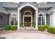 Grand entryway with stone accents, wood double doors, and manicured shrubs at 9125 Patrick Pl, Winston, GA 30187