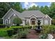 Stately gray stucco home with lush front garden and decorative fountain at 9125 Patrick Pl, Winston, GA 30187