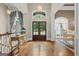 Bright foyer with wood floors, statement lighting, and view to dining area at 9125 Patrick Pl, Winston, GA 30187