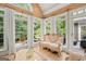 Bright sunroom with an ornate sofa and lots of natural light and access to an outdoor deck at 9125 Patrick Pl, Winston, GA 30187
