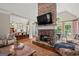 Open-concept living room with fireplace, wood floors, and view to the kitchen at 9125 Patrick Pl, Winston, GA 30187