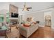 Cozy living room featuring stone fireplace, wood floors, and ample seating at 9125 Patrick Pl, Winston, GA 30187