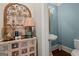 Charming powder room with unique vanity and ornate mirror at 9125 Patrick Pl, Winston, GA 30187