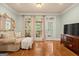 Bedroom sitting area with hardwood floors, cozy seating, and access to the outdoors at 9125 Patrick Pl, Winston, GA 30187