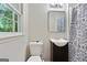 Modern bathroom with dark vanity, with toilet at 260 Pinehurst Dr, Stockbridge, GA 30281