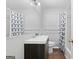 Modern bathroom with dark vanity, with shower and bathtub at 260 Pinehurst Dr, Stockbridge, GA 30281