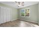 Bright bedroom features light-green walls, wood floors, and a closet at 260 Pinehurst Dr, Stockbridge, GA 30281