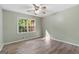 This bedroom features wood flooring and a ceiling fan, with natural light from the window at 260 Pinehurst Dr, Stockbridge, GA 30281