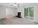 Cozy living room boasting new flooring, a fireplace, and sliding glass doors to an outdoor deck at 260 Pinehurst Dr, Stockbridge, GA 30281