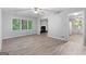 Open-concept living room with new flooring, a fireplace, and views into other rooms at 260 Pinehurst Dr, Stockbridge, GA 30281