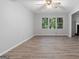 Spacious living room featuring new flooring and a view of trees outside the window at 260 Pinehurst Dr, Stockbridge, GA 30281