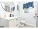 Renovated bathroom with modern vanity, round mirror, and stylish fixtures at 650 Lynhurst Sw Dr, Atlanta, GA 30311