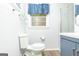Modern bathroom with blue vanity, new fixtures, and a shower with glass doors at 650 Lynhurst Sw Dr, Atlanta, GA 30311
