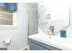 Updated bathroom with a blue vanity, marble shower, and updated fixtures at 650 Lynhurst Sw Dr, Atlanta, GA 30311