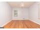 Neutral bedroom features hardwood floors, a modern light fixture, and a bright window at 650 Lynhurst Sw Dr, Atlanta, GA 30311