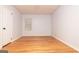 Empty bedroom with neutral walls, hardwood floors, and a bright window with blinds at 650 Lynhurst Sw Dr, Atlanta, GA 30311