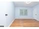 Bright room with hardwood floors, a window, and two doors providing easy access at 650 Lynhurst Sw Dr, Atlanta, GA 30311