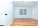 Bright room with hardwood floors, a window, and two doors providing easy access at 650 Lynhurst Sw Dr, Atlanta, GA 30311