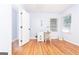 Cozy bedroom with white walls, wood floors, and a white desk by the window at 650 Lynhurst Sw Dr, Atlanta, GA 30311
