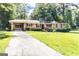 Charming brick home with a well-manicured lawn and covered parking at 650 Lynhurst Sw Dr, Atlanta, GA 30311