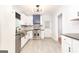 Modern kitchen with stainless steel appliances, dark counters, and white cabinets at 650 Lynhurst Sw Dr, Atlanta, GA 30311