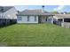 View of backyard featuring a lawn, a partial fence and covered porch at 537 Goldfinch Way, Stockbridge, GA 30281