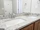 Bathroom featuring double sinks, granite countertop, stainless steel faucets, and mirror at 537 Goldfinch Way, Stockbridge, GA 30281