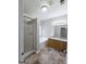 Bathroom featuring double vanity sinks, soaking tub, walk-in shower with glass door, and tile flooring at 537 Goldfinch Way, Stockbridge, GA 30281