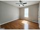 Comfortable bedroom featuring hardwood floors, neutral walls, and a ceiling fan at 537 Goldfinch Way, Stockbridge, GA 30281