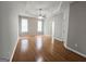 Spacious bedroom with hardwood floors, ceiling fan, and natural light from two windows at 537 Goldfinch Way, Stockbridge, GA 30281